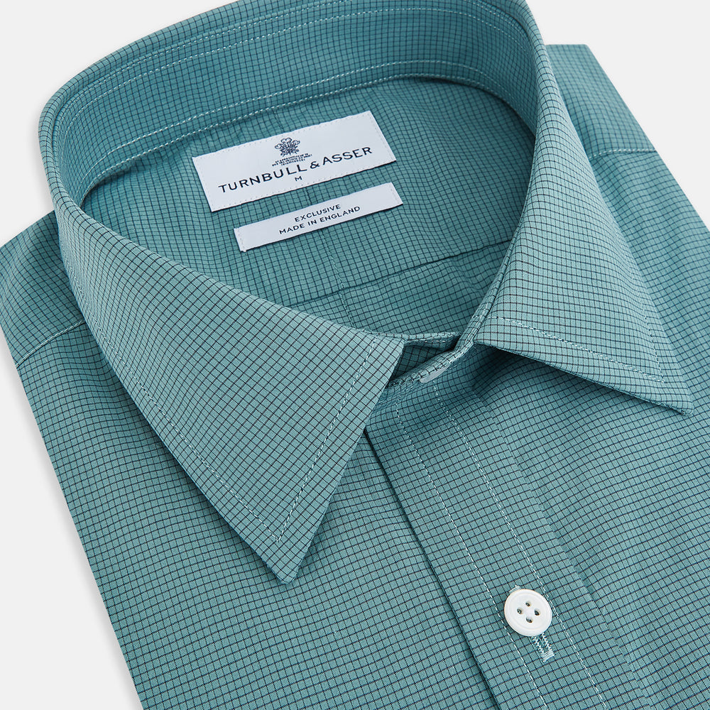 A Fine Checked Sage Green Weekend Fit Shirt in Cotton by Turnbull & Asser UK, featuring long sleeves, a button-up front, chest pocket, buttoned cuffs, and a classic collar—displayed on a white background—offers a modern twist reminiscent of the timeless appeal of classic checked shirts.