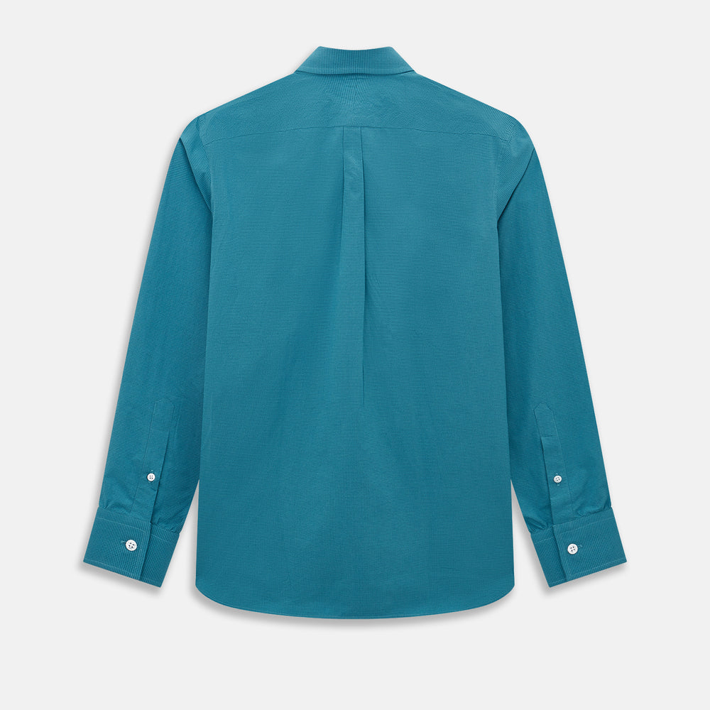 Here’s a rewritten version using your product data: The Turnbull & Asser UK Fine Checked Turquoise Blue Weekend Fit Shirt in Cotton is a men’s long-sleeve button-up, featuring a chest pocket, white buttons, and a pointed collar, shown laid flat against a white background.
