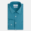 View 5 of product Here’s a rewritten version using your product data: The Turnbull & Asser UK Fine Checked Turquoise Blue Weekend Fit Shirt in Cotton is a men’s long-sleeve button-up, featuring a chest pocket, white buttons, and a pointed collar, shown laid flat against a white background.