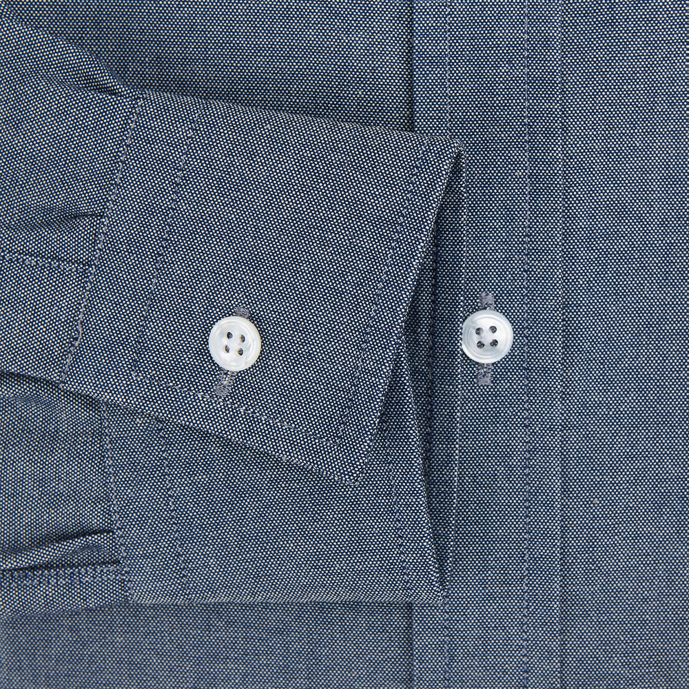 The Turnbull & Asser Steel Blue Richmond Shirt is a long-sleeved, button-up dress shirt with a Derby collar, single chest pocket, and buttoned cuffs—shown on a plain white background.