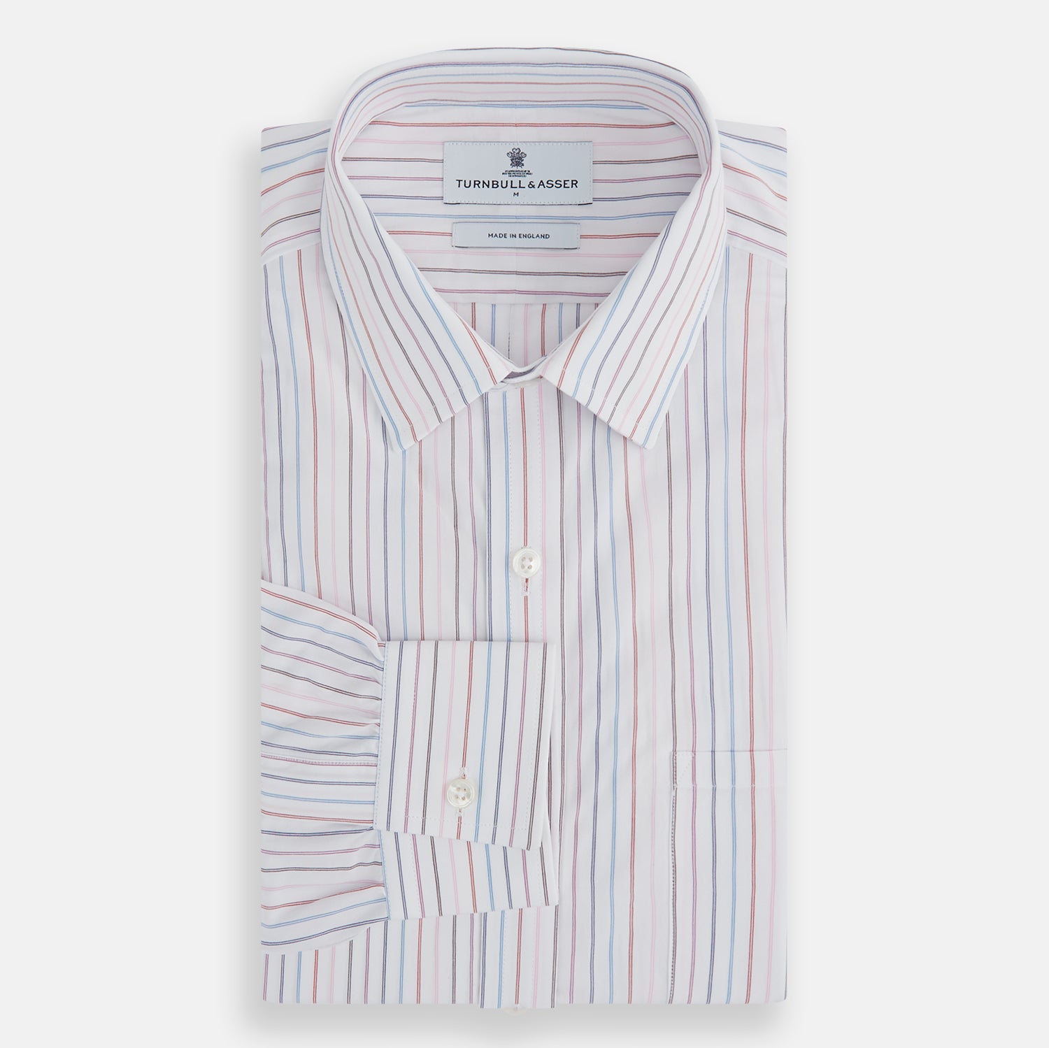 View 4 of product The Turnbull & Asser Multi Pencil Stripe Richmond Shirt features long sleeves, a Derby collar, left chest pocket, and light blue, red, and white pencil stripes. It is laid flat on a white background.