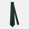 View 2 of product A Dark Green Grenadine Silk Tie by Turnbull & Asser UK, featuring a textured knit, is rolled up at one end and displayed on a white background.