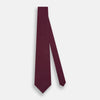 View 2 of product A rolled-up Turnbull & Asser Green and Magenta Micro Dot Silk Tie, featuring small, evenly spaced magenta dots on green silk, displayed on a plain white background—an ideal accessory for sophisticated outfits.