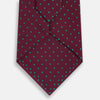 View 3 of product A rolled-up Turnbull & Asser Green and Magenta Micro Dot Silk Tie, featuring small, evenly spaced magenta dots on green silk, displayed on a plain white background—an ideal accessory for sophisticated outfits.