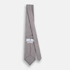 View 4 of product The Turnbull & Asser Grey and White Diamond Silk Tie features a refined geometric pattern, combining silver triangles on a white background for an elegant look.