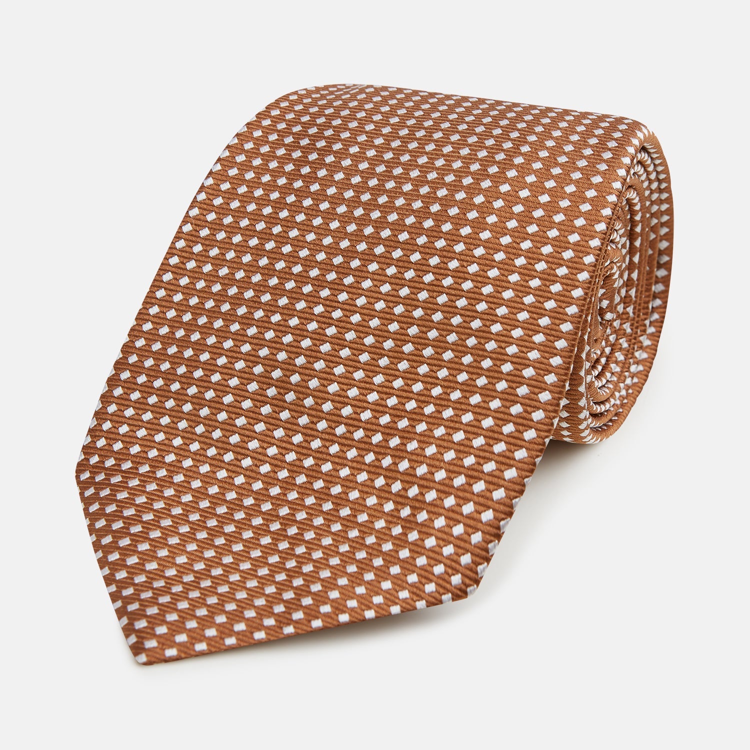 View 1 of product The Turnbull & Asser Brown and White Diamond Silk Tie features a repeating small geometric pattern and is displayed rolled up on a plain white background.