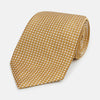 View 1 of product A Turnbull & Asser Light Brown and White Diamond Silk Tie, featuring a refined white geometric pattern, ideal for modern office wear, shown rolled on a plain white background.
