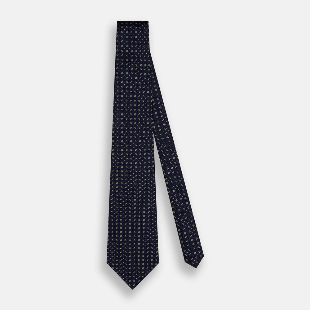 The Turnbull & Asser Navy and Light Green Circle Silk Tie features a navy base with small light green circular patterns, crafted from fine silk.