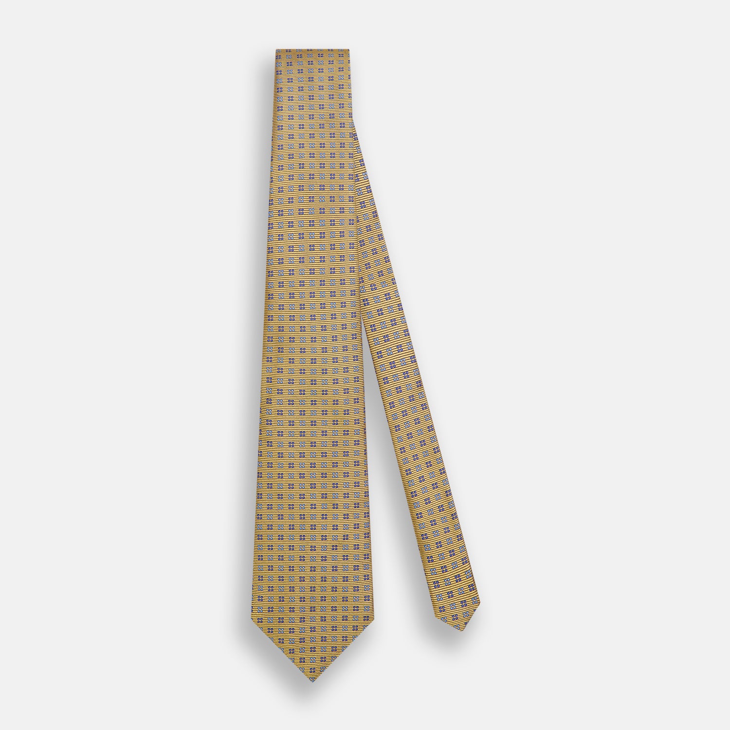 View 2 of product The Turnbull & Asser Blue and Gold Multi Dot Silk Tie features blue and gold dots in neat rows, presented rolled up on a white background.