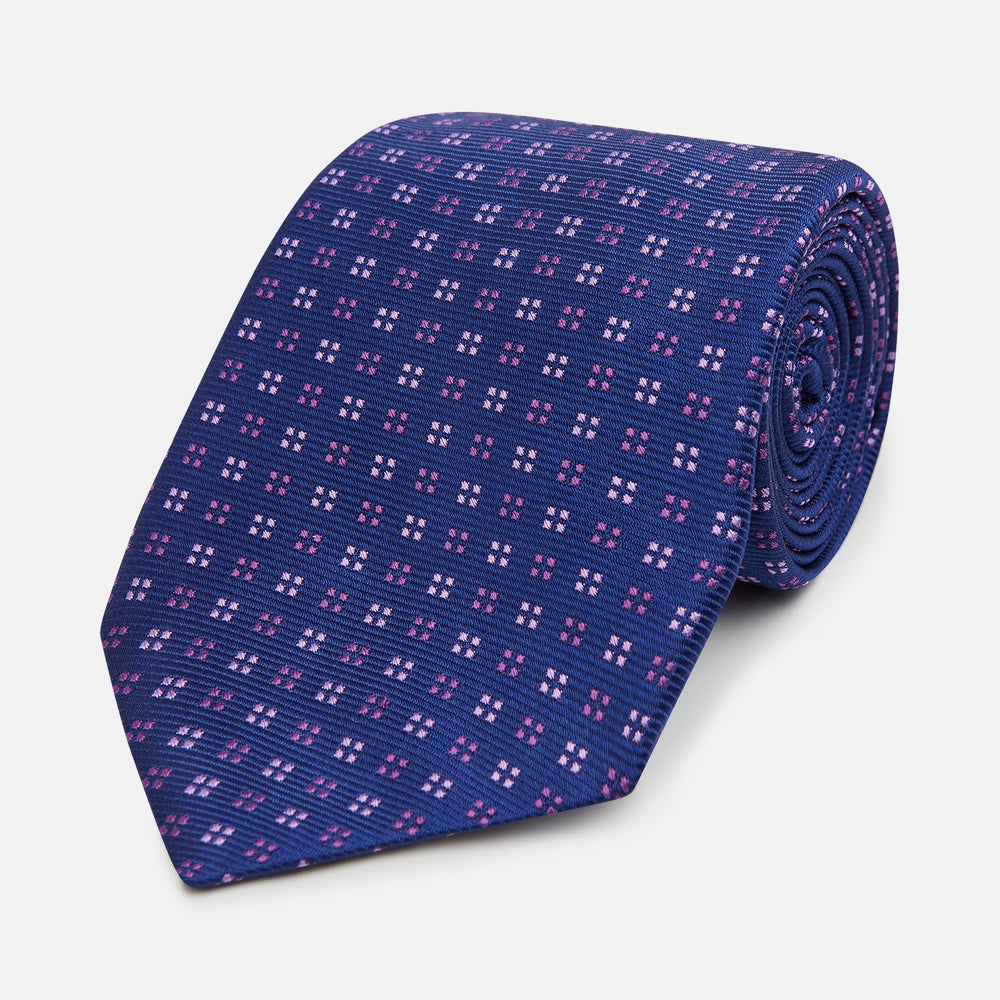 The Turnbull & Asser Blue and Pink Multi Dot Silk Tie, featuring a refined dot pattern, is displayed on a white background—an elegant accessory perfect for modern office style.