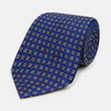 View 1 of product The Turnbull & Asser Blue and Yellow Multi Dot Silk Tie features a geometric yellow and white pattern, ideal for modern office wear. The elegant silk tie is showcased rolled up on a plain white background.