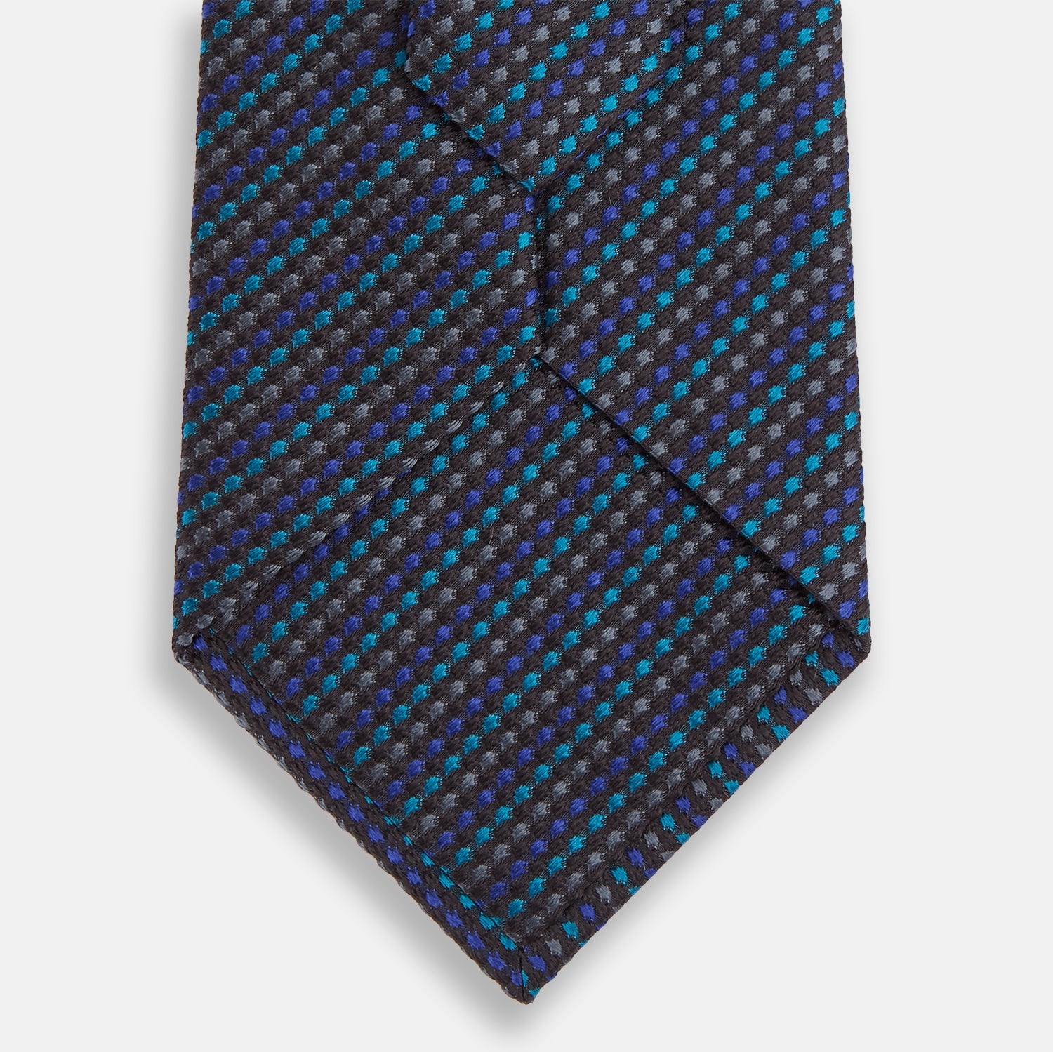 View 3 of product A close-up of the Turnbull & Asser Navy Multi Silk Tie, showcasing its textured design with small blue and black checks, exuding refined elegance against a plain white background.