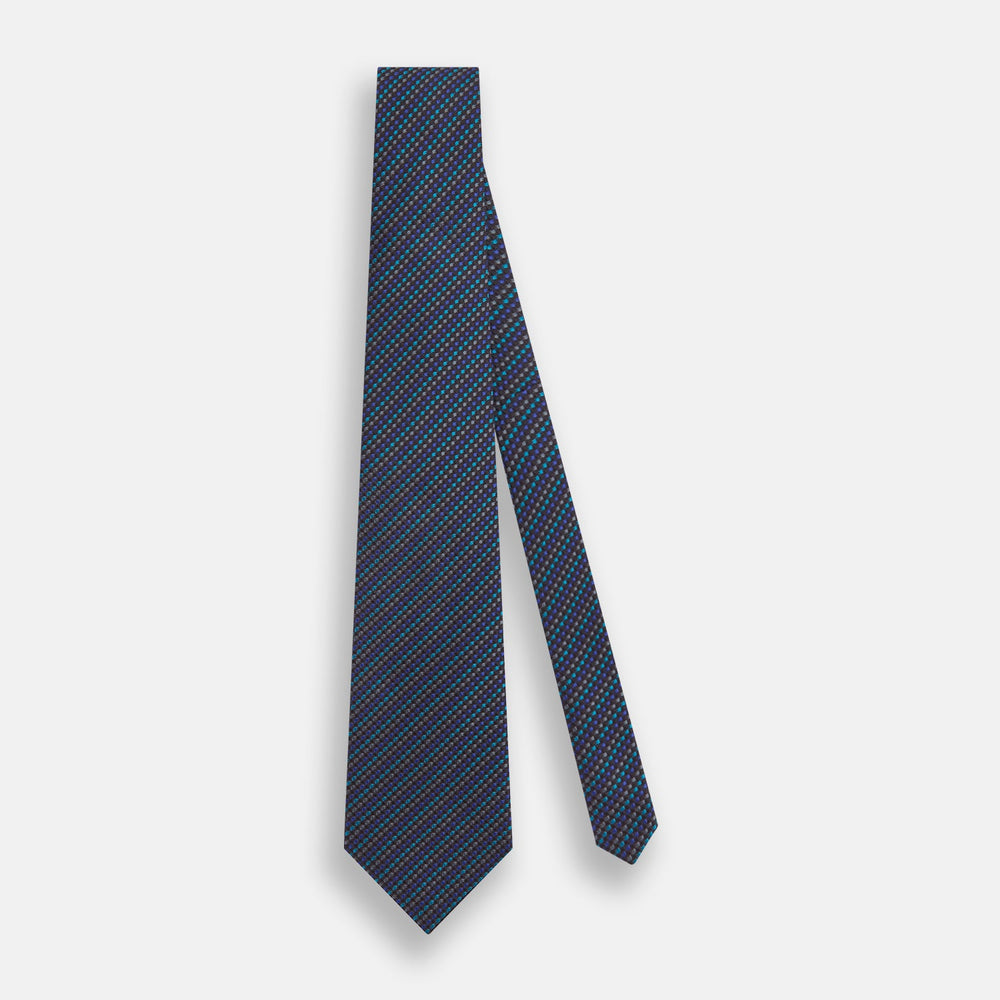 A close-up of the Turnbull & Asser Navy Multi Silk Tie, showcasing its textured design with small blue and black checks, exuding refined elegance against a plain white background.