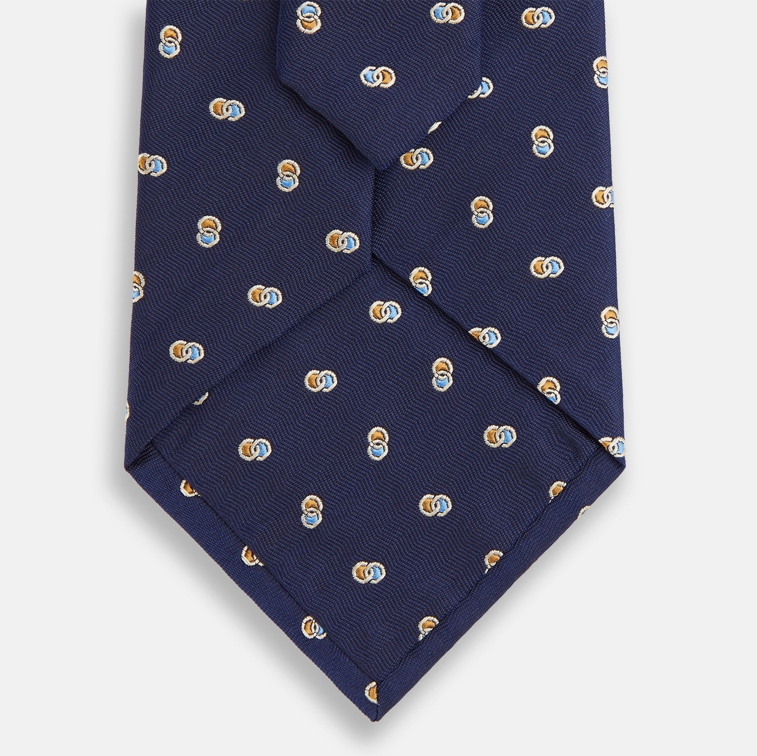 View 3 of product The Turnbull & Asser Blue and Yellow Links Silk Tie features a refined zigzag texture and a repeating pattern of interlocking gold and blue rings—the perfect sophisticated accent for the modern gentleman, especially paired with Turnbull & Asser shirts.