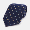 View 1 of product The Turnbull & Asser Blue and Yellow Links Silk Tie features a refined zigzag texture and a repeating pattern of interlocking gold and blue rings—the perfect sophisticated accent for the modern gentleman, especially paired with Turnbull & Asser shirts.