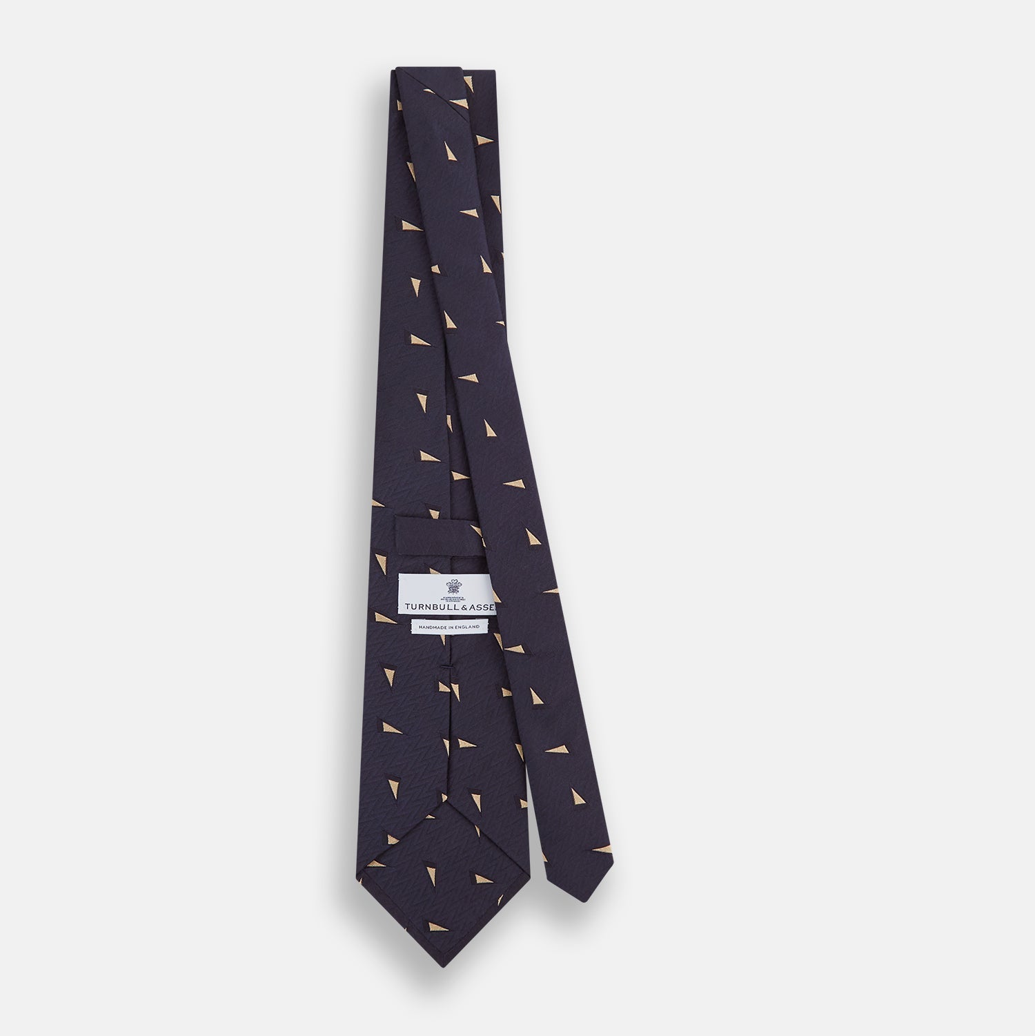 View 4 of product The Navy Triangle Silk Tie by Turnbull & Asser features an elegant gold micro triangle pattern on navy silk, making it a sophisticated accessory that pairs perfectly with Turnbull & Asser shirts.