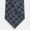 View 3 of product The Turnbull & Asser Navy Fine Double Check Silk Tie, featuring a refined navy, light blue, and tan plaid, is neatly rolled on a white background—an ideal accessory to complement any Turnbull & Asser shirt.