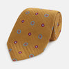 View 1 of product The Gold Motif Silk Tie by Turnbull & Asser features a refined yellow herringbone texture with blue and red floral accents, capturing British elegance—a sophisticated addition to any discriminating wardrobe.