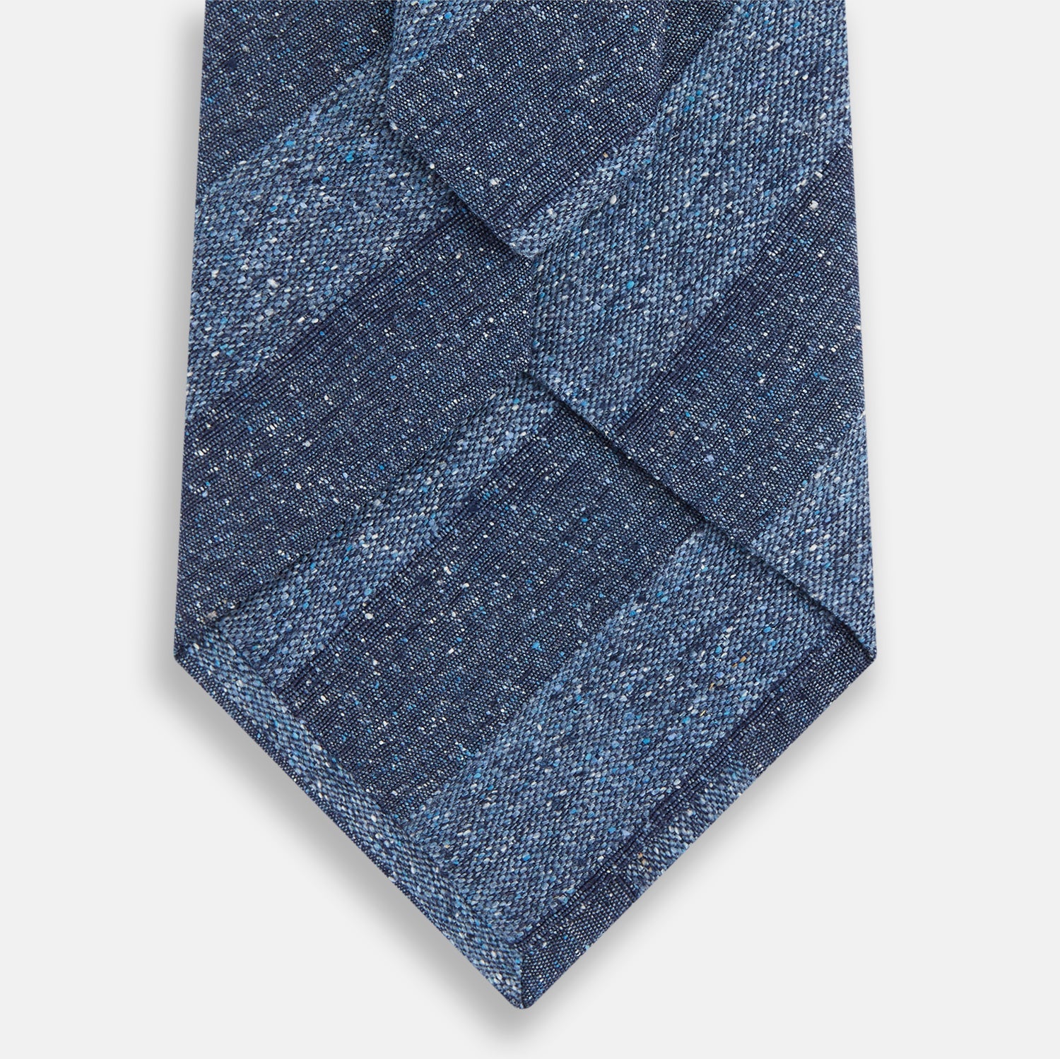 View 3 of product The Turnbull & Asser Blue Block Stripe Silk Tie, featuring a refined striped pattern, is elegantly showcased rolled up against a plain white background.
