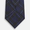 View 3 of product A rolled-up Green Tartan Silk Tie by Turnbull & Asser, featuring a classic tartan pattern on green silk and displayed against a light background—an elegant accessory to pair with Turnbull & Asser shirts.