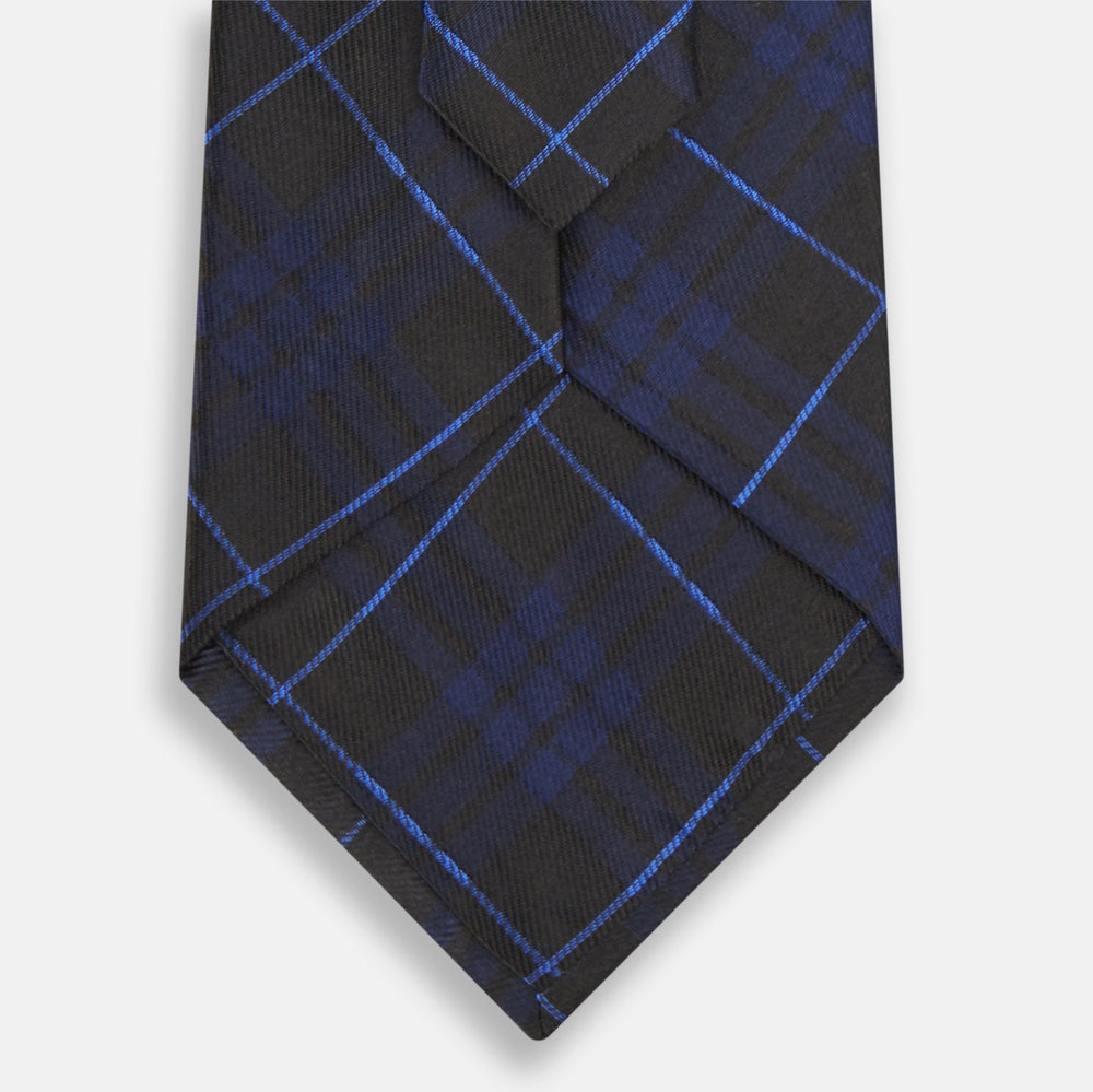 A rolled-up Green Tartan Silk Tie by Turnbull & Asser, featuring a classic tartan pattern on green silk and displayed against a light background—an elegant accessory to pair with Turnbull & Asser shirts.