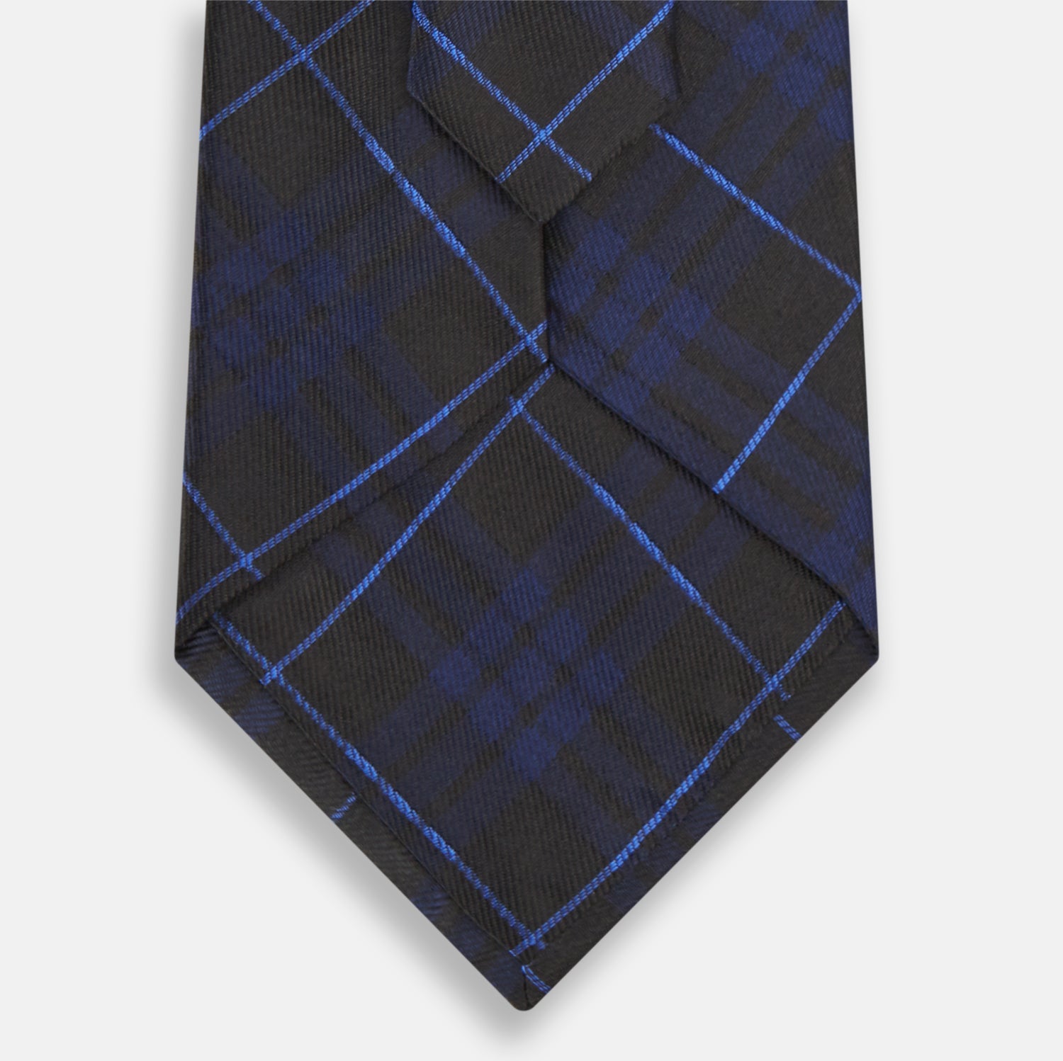View 3 of product A rolled-up Green Tartan Silk Tie by Turnbull & Asser, featuring a classic tartan pattern on green silk and displayed against a light background—an elegant accessory to pair with Turnbull & Asser shirts.