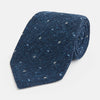 View 1 of product The Turnbull & Asser Navy Micro Paisley Silk Tie features a rolled-up navy blue silk with a subtle speckled texture and small light blue paisley patterns, perfect for enhancing any formal collection, shown on a white background.