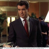 View 2 of product The Turnbull & Asser Die Another Day Stripe Silk Tie, as seen on James Bond, showcases a vibrant orange, red, and purple woven pattern, elegantly rolled and displayed against a white background.