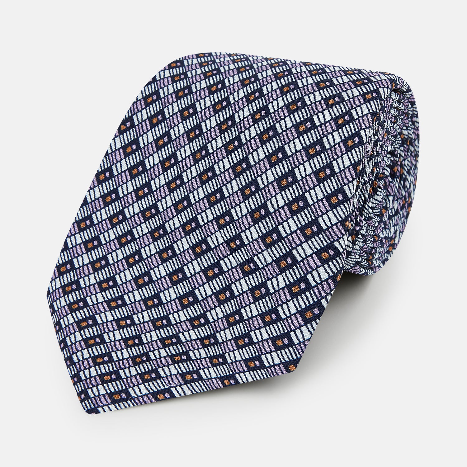View 1 of product The Turnbull & Asser UK Lilac Hatched-Rectangle Neats Silk Tie features a repeating geometric pattern in navy blue, light blue, and orange on a white background, shown neatly rolled on a white surface.