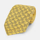 The Turnbull & Asser UK Yellow Floral Jigsaw Printed Silk Tie is neatly rolled to showcase its vibrant yellow hue and intricate floral jigsaw print.