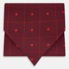 View 1 of product The Tulip Red Concentric Diamond Printed Silk Cravat from Turnbull & Asser UK features a bold red and black geometric pattern, creating an optical illusion effect and smart British style.