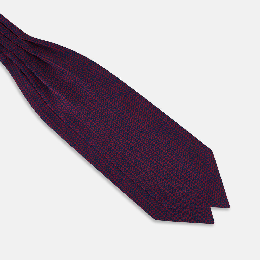 The Burgundy Micro-Dot Bar Printed Silk Cravat by Turnbull & Asser UK features a British style with a navy background, vertical red dots, and diagonal burgundy and navy stripes.