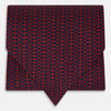 View 1 of product The Red Micro-Dot Bar Printed Silk Cravat from Turnbull & Asser UK features a geometric red and navy micro-dot pattern—a refined accessory inspired by classic British style, perfect for elegant weddings.