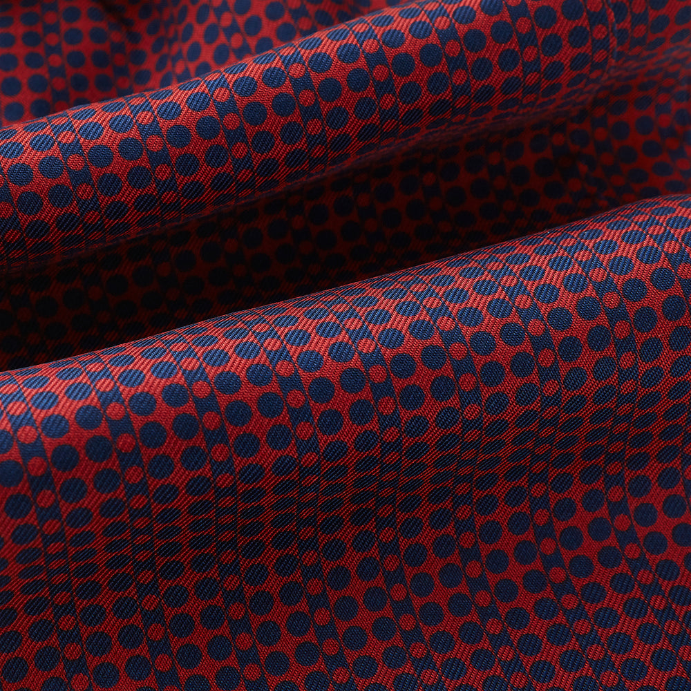 The Red Micro-Dot Bar Printed Silk Cravat from Turnbull & Asser UK features a geometric red and navy micro-dot pattern—a refined accessory inspired by classic British style, perfect for elegant weddings.