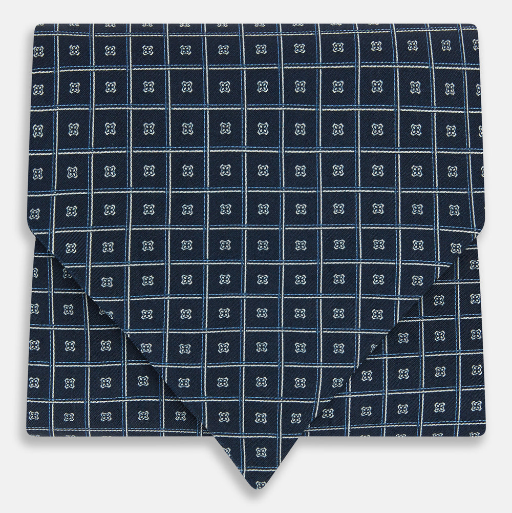 Geometric Navy Quatrefoil Motif Ascot Tie in Silk in navy blue with a repeating white and light blue geometric quatrefoil motif and fine grid lines.