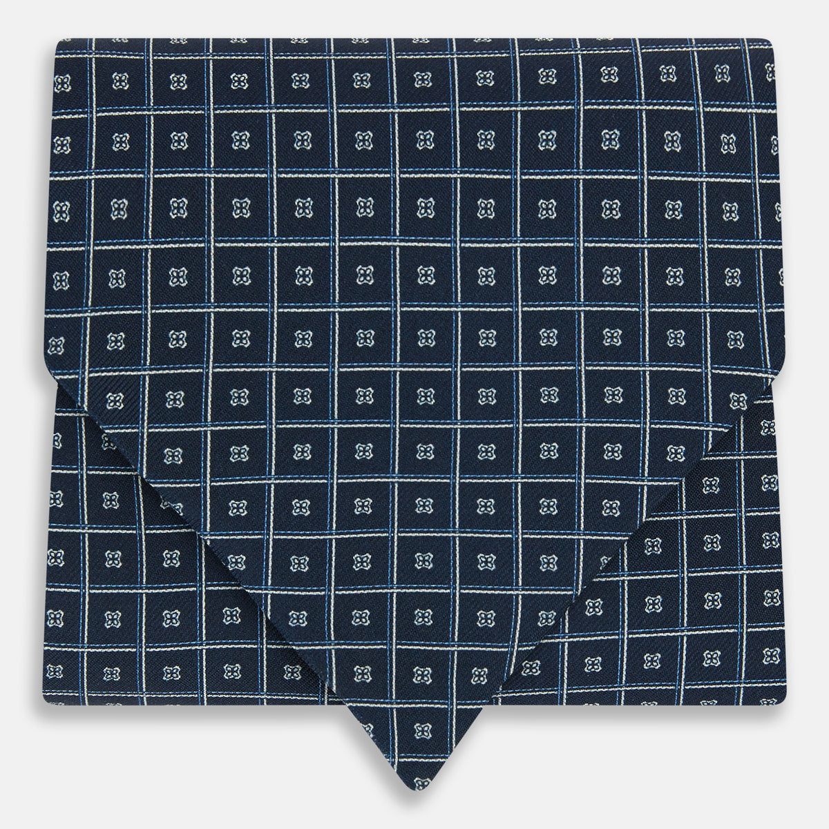 View 1 of product Geometric Navy Quatrefoil Motif Ascot Tie in Silk in navy blue with a repeating white and light blue geometric quatrefoil motif and fine grid lines.