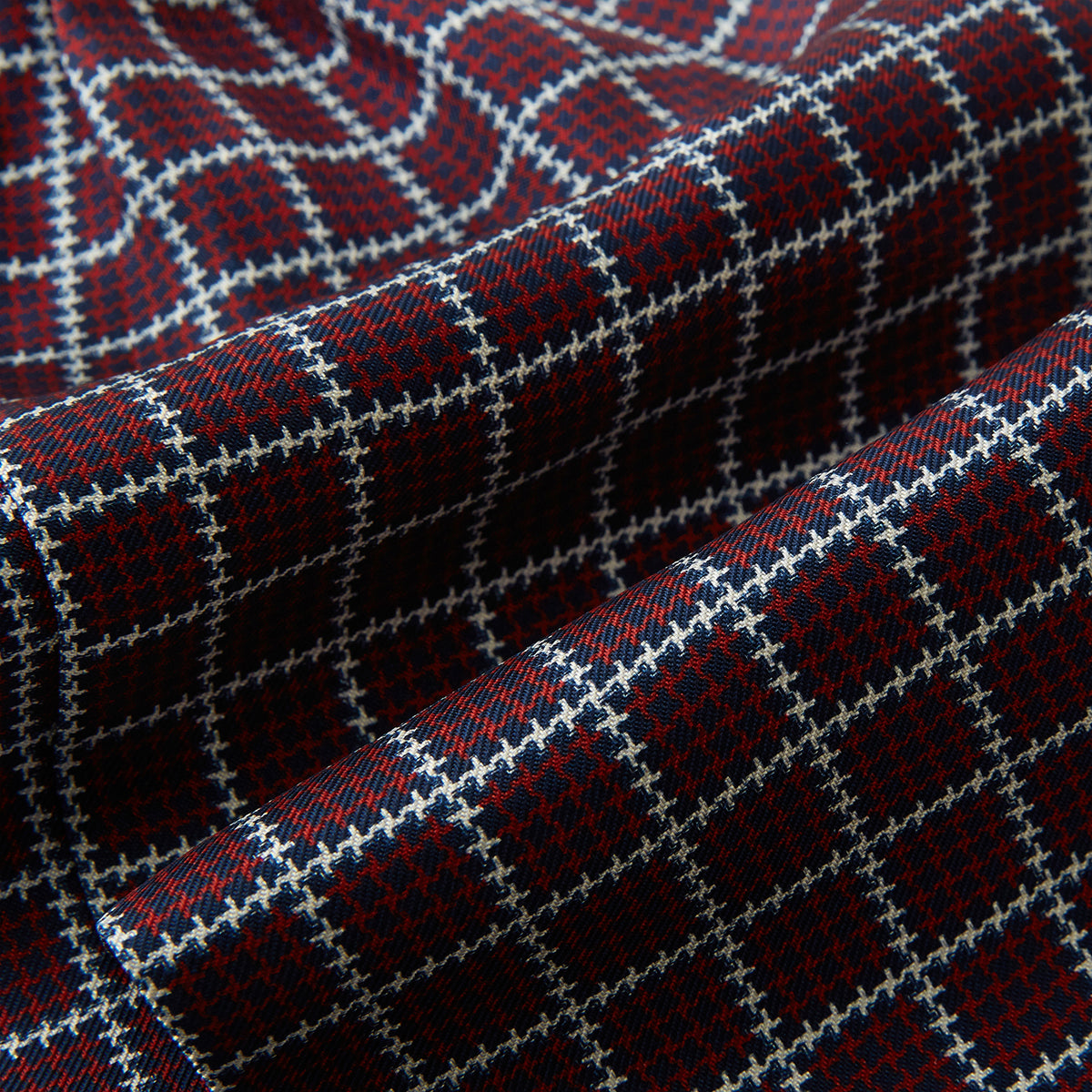 View 4 of product Turnbull & Asser UK Houndstooth Red Ascot Tie in silk, featuring a red printed houndstooth and windowpane check pattern of navy blue and white.
