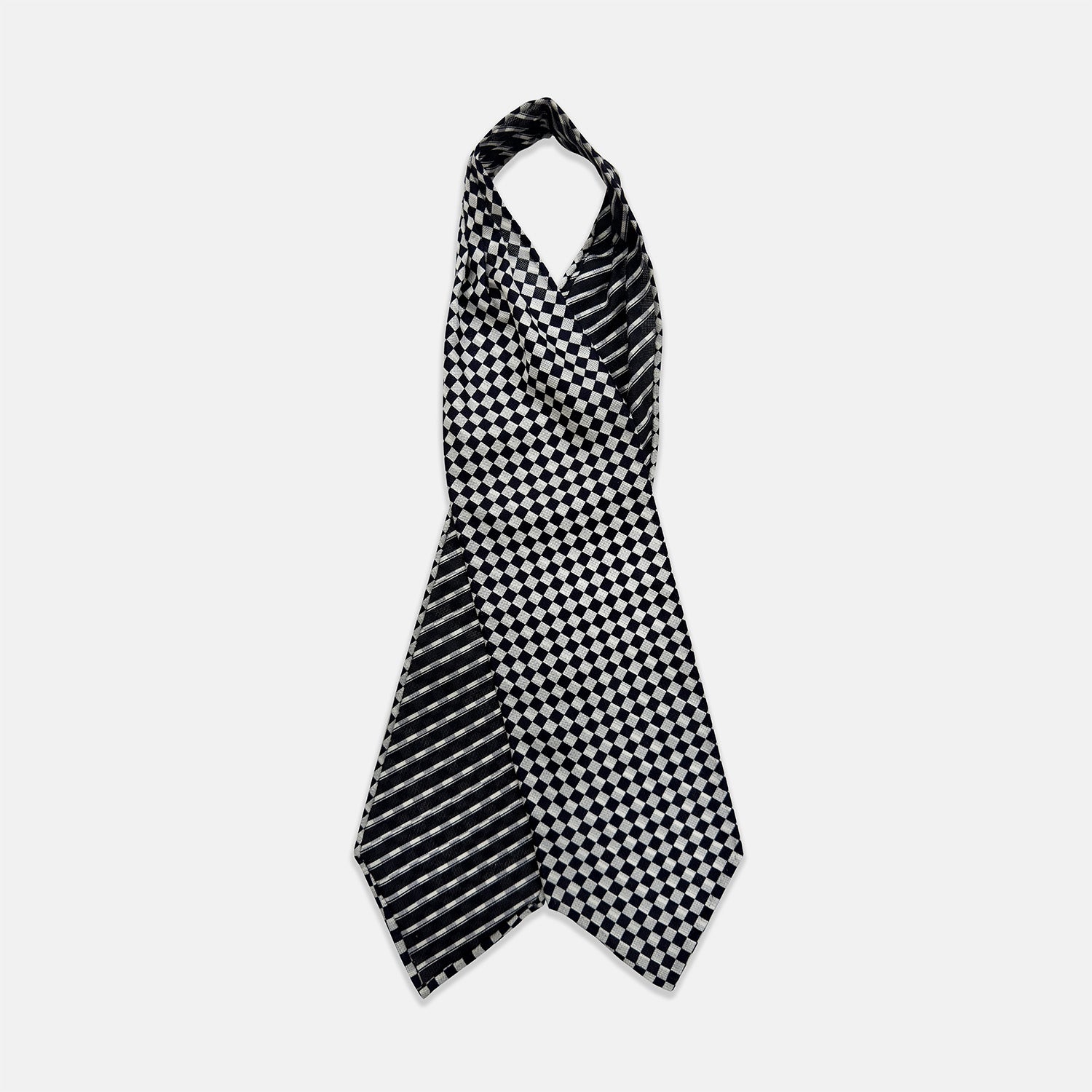 View 1 of product A Chequered Navy & White Cravat in Silk by Turnbull & Asser UK, featuring a checkered pattern on one side and diagonal stripes on the other, is laid flat on a white background.