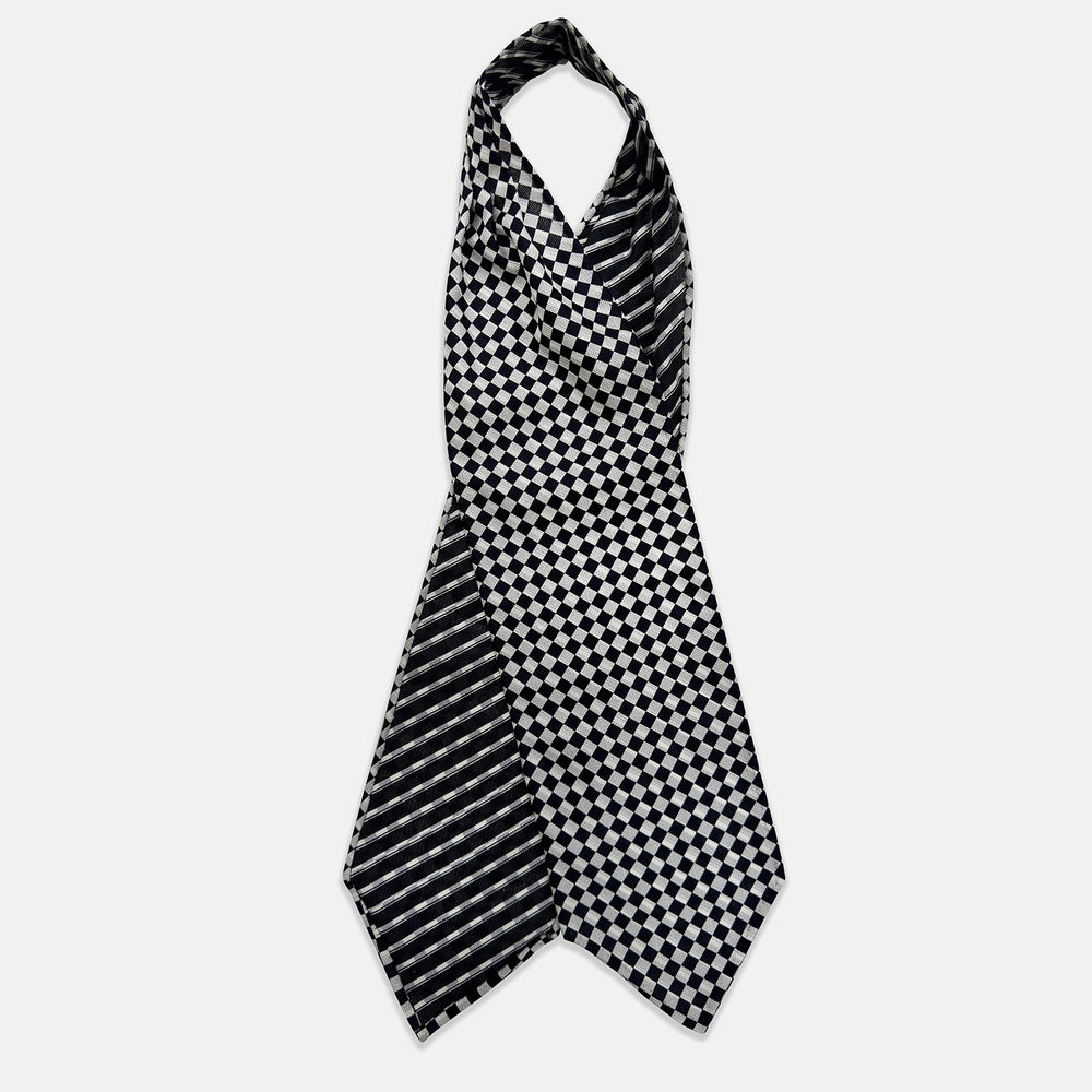 A folded Chequered Navy & White Silk Cravat by Turnbull & Asser UK, featuring a timeless diamond checkered pattern that channels classic British motoring elegance, displayed on a plain white background. Ideal as a double-sided silk accessory to elevate your ensemble for the Concours of Elegance 2026.