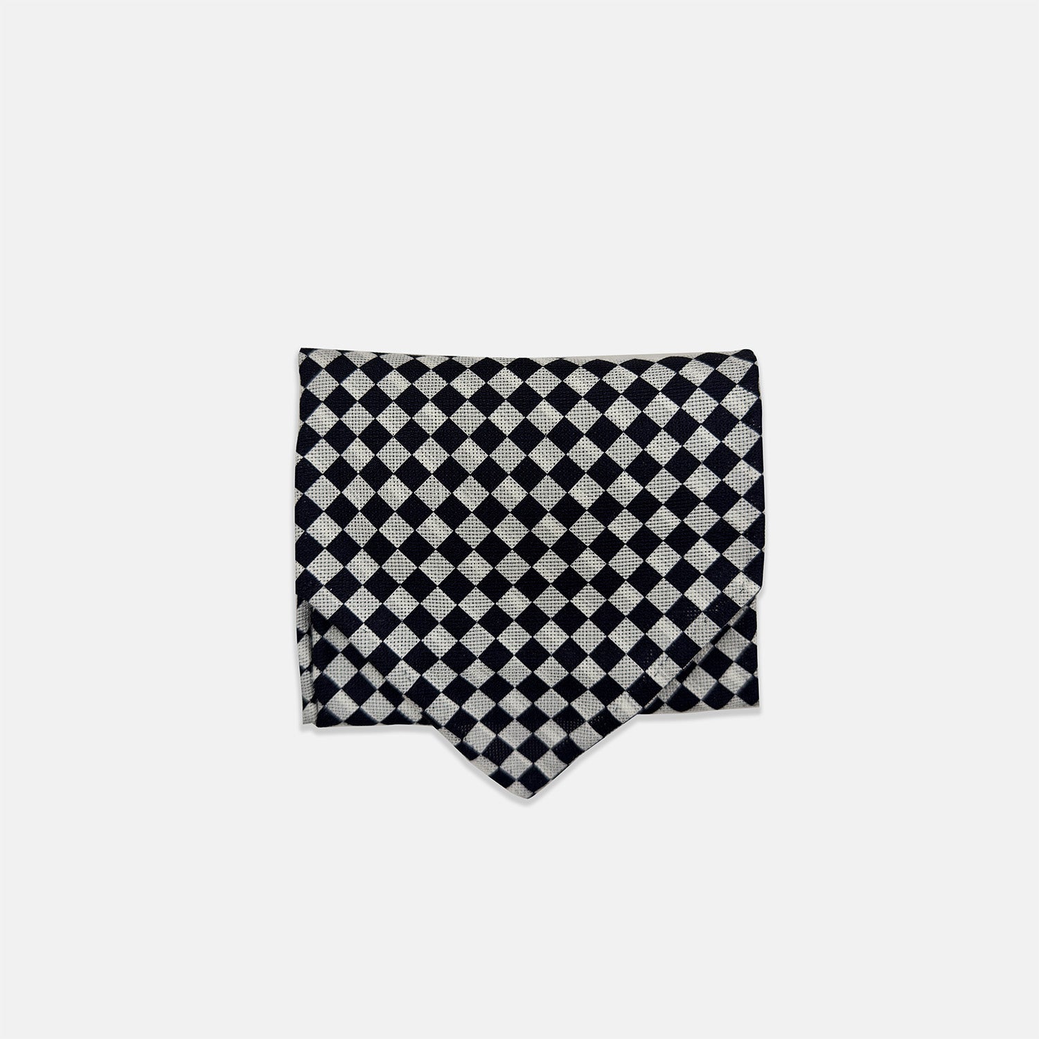 View 3 of product A Chequered Navy & White Cravat in Silk by Turnbull & Asser UK, featuring a checkered pattern on one side and diagonal stripes on the other, is laid flat on a white background.