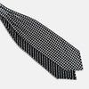 View 3 of product A folded Chequered Navy & White Silk Cravat by Turnbull & Asser UK, featuring a timeless diamond checkered pattern that channels classic British motoring elegance, displayed on a plain white background. Ideal as a double-sided silk accessory to elevate your ensemble for the Concours of Elegance 2026.
