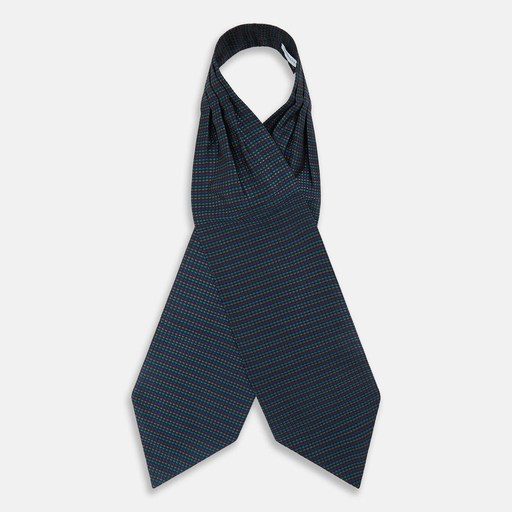 Turnbull & Asser's Navy Multi Silk Cravat pairs perfectly with a folded pocket square featuring a grid of small blue and black dots on a dark background—an ideal touch for adding flair to your next formal outfit.