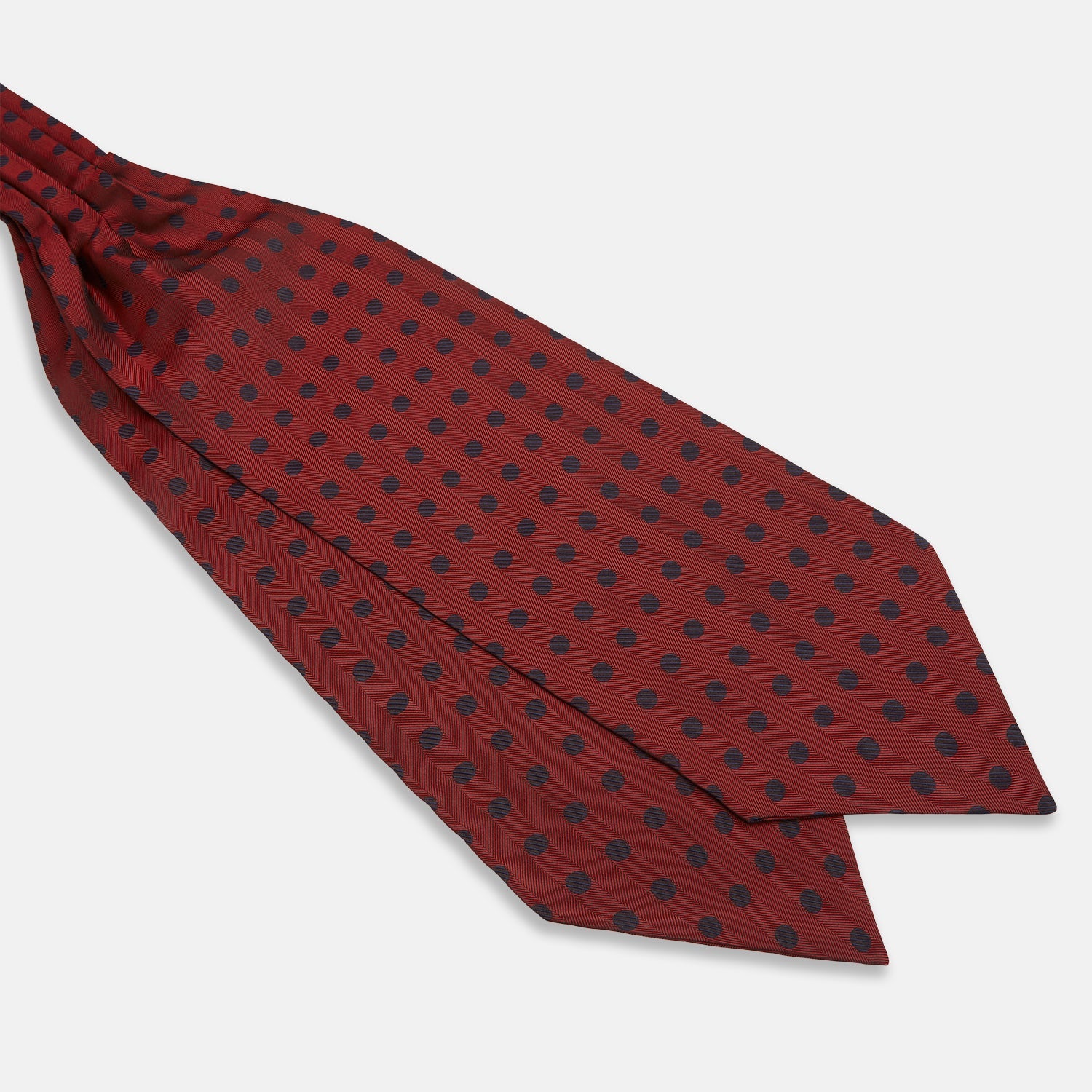 View 3 of product The Turnbull & Asser Red Dot Silk Cravat is a red silk accessory with evenly spaced dark blue polka dots—neatly folded for a sharp finish and perfect for pairing with your favorite handmade neckwear.