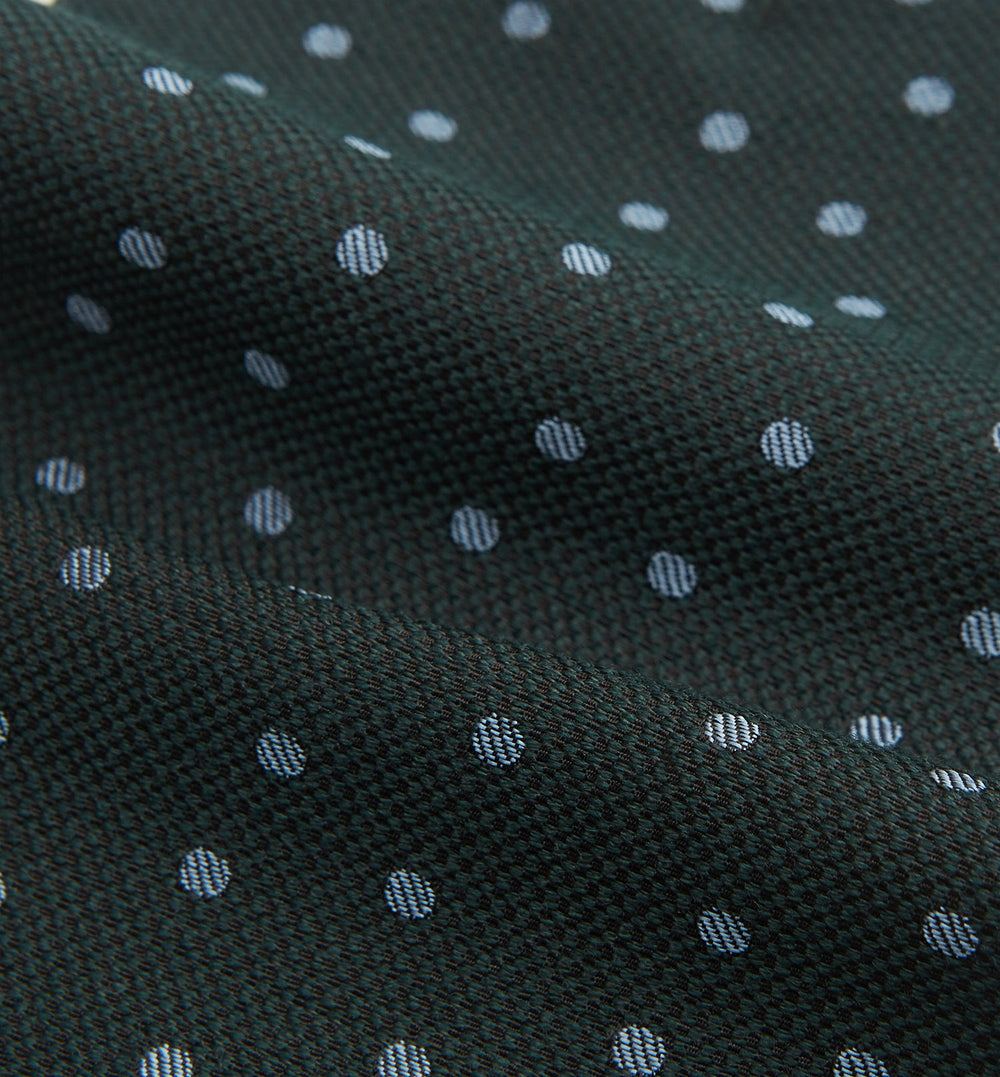 The Turnbull & Asser Pale Blue and Green Micro Dot Cravat features a refined micro dot pattern, blending pale blue and green for a sophisticated look—perfect for adding elegance to any ensemble.