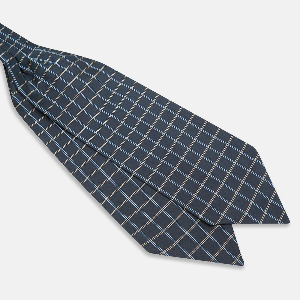 The Navy Fine Double Check Silk Cravat by Turnbull & Asser features a grid pattern in light blue and white lines—an elegant formal men's accessory, neatly folded with the pointed end at the bottom.
