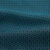 View 4 of product The Turnbull & Asser Turquoise Micro Hexagon Cravat is neatly folded to show a triangular point, displayed with a matching pocket square featuring a subtle hexagon pattern, all set against a white background.