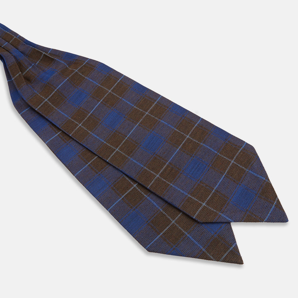 The Turnbull & Asser Blue and Brown Tartan Silk Blend Cravat is neatly folded with sharp creases and displayed on a white background.