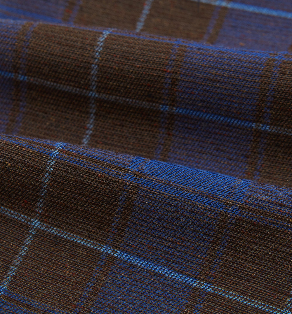 The Turnbull & Asser Blue and Brown Tartan Silk Blend Cravat is neatly folded with sharp creases and displayed on a white background.