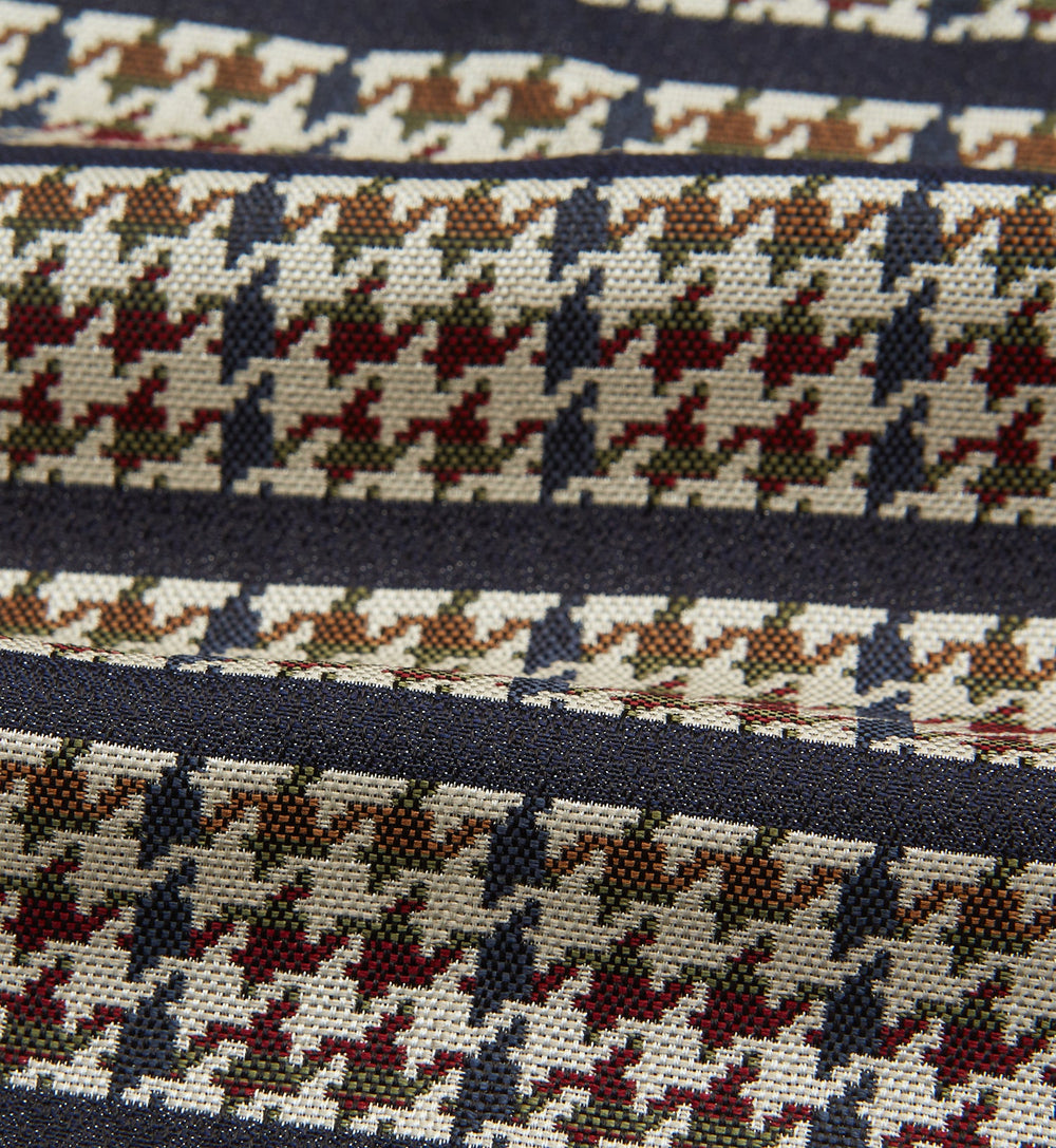 A folded pocket square with a houndstooth pattern in cream, brown, olive green, and burgundy with navy stripes—ideal for pairing with the Turnbull & Asser Brown Houndstooth Silk Cravat.