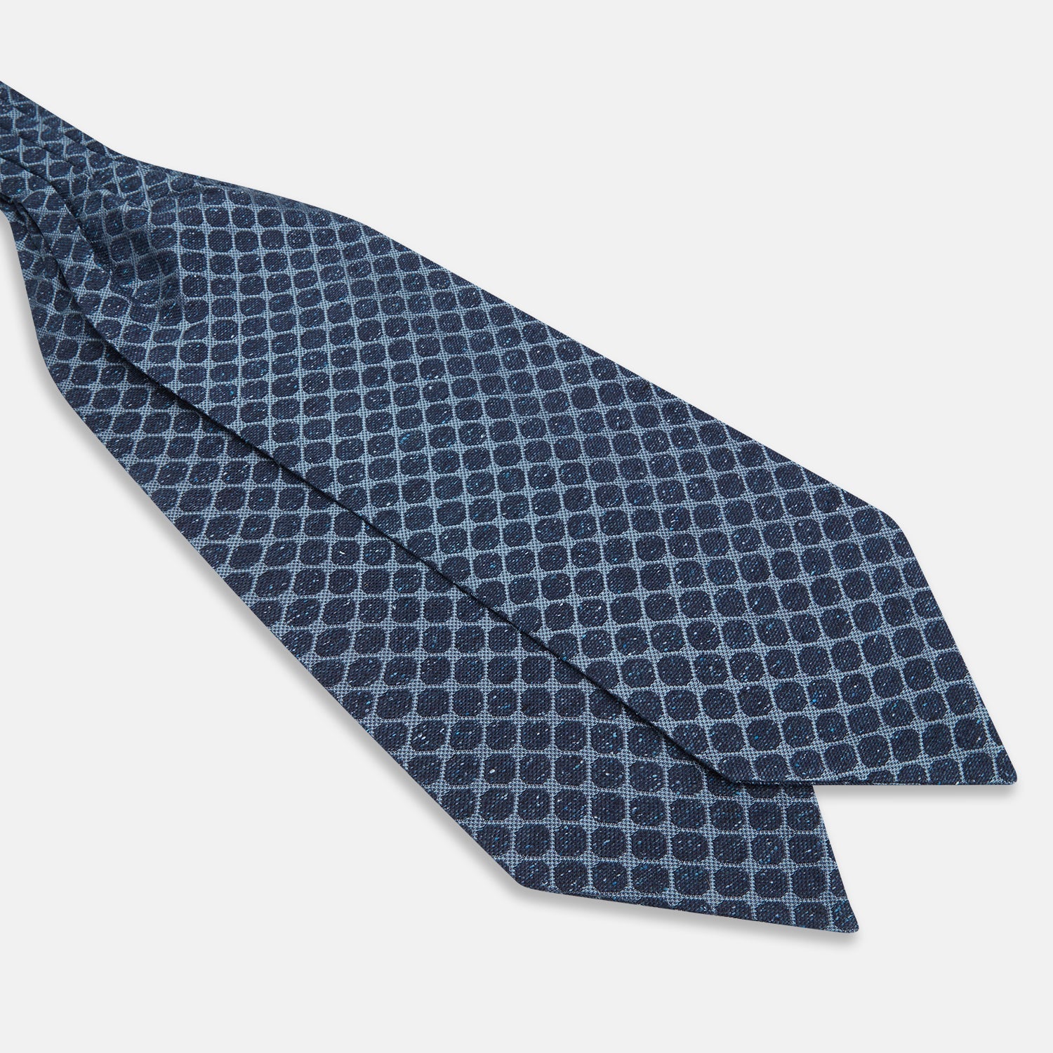 View 3 of product The Turnbull & Asser Navy Grid Silk Cravat features a textured hexagonal grid in dark and light blue on white—a refined, formal accessory perfect for any occasion.